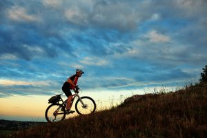 Silhouette of a bike on sky background on sunset
